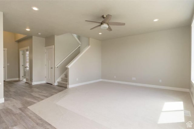 unfurnished living room with ceiling fan and light wood-type flooring