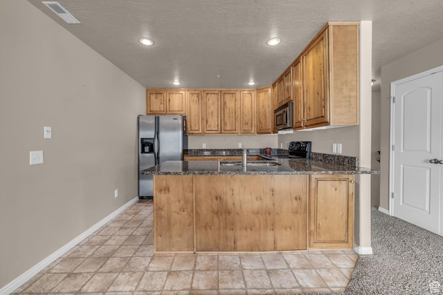 67 S 930 E, American Fork, UT 84003 - kitchen featuring sink, kitchen peninsula, dark stone counters, a textured ceiling, and appliances with stainless steel finishes