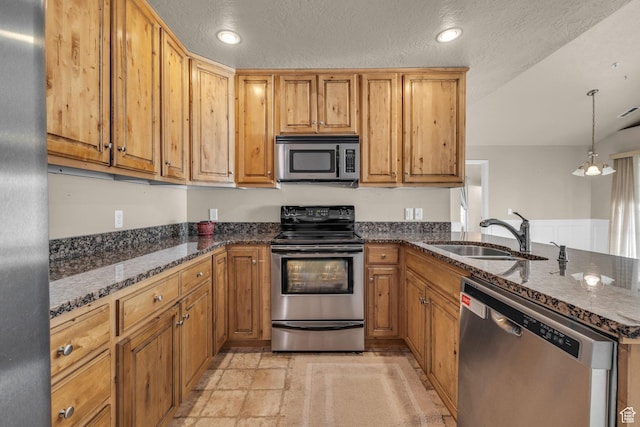 67 S 930 E, American Fork, UT 84003 - kitchen with sink, hanging light fixtures, dark stone counters, a textured ceiling, and appliances with stainless steel finishes