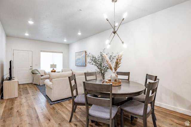 dining room with baseboards, light wood-style floors, and recessed lighting