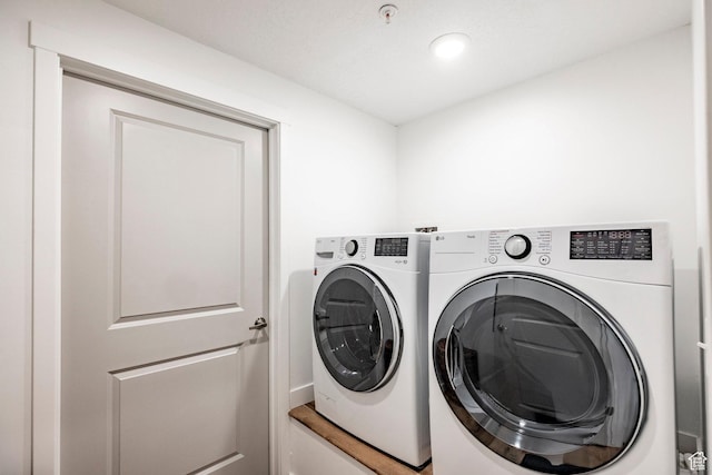 washroom featuring separate washer and dryer, laundry area, and recessed lighting