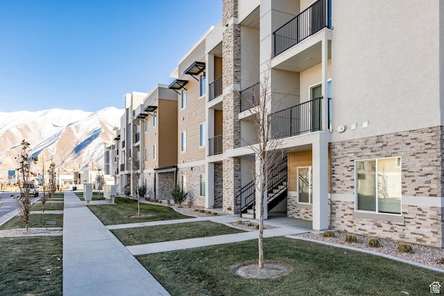 view of property with a mountain view and a residential view