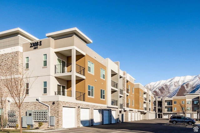 view of property featuring an attached garage and a mountain view