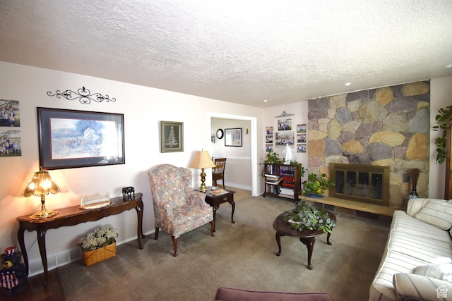 carpeted living room with a stone fireplace, a textured ceiling, and baseboards