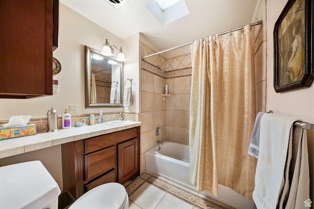 bathroom with tile patterned flooring, shower / bathtub combination with curtain, toilet, vanity, and a skylight