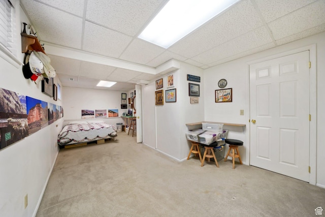 bedroom featuring baseboards, a paneled ceiling, and carpet