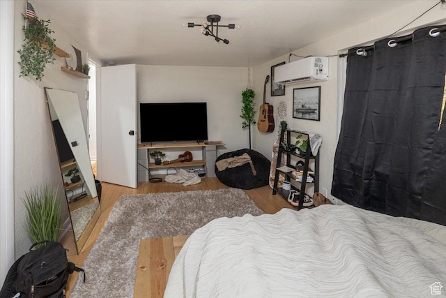 138 Crockett Ave, Logan, UT 84321 - bedroom with an AC wall unit and light hardwood / wood-style flooring