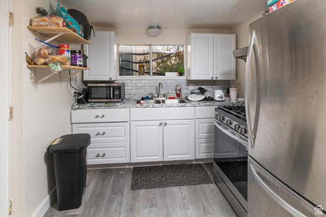 138 Crockett Ave, Logan, UT 84321 - kitchen featuring stainless steel appliances, white cabinetry, light countertops, and open shelves