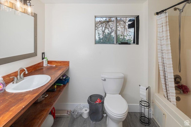 138 Crockett Ave, Logan, UT 84321 - full bathroom featuring shower / tub combo with curtain, hardwood / wood-style floors, vanity, and toilet