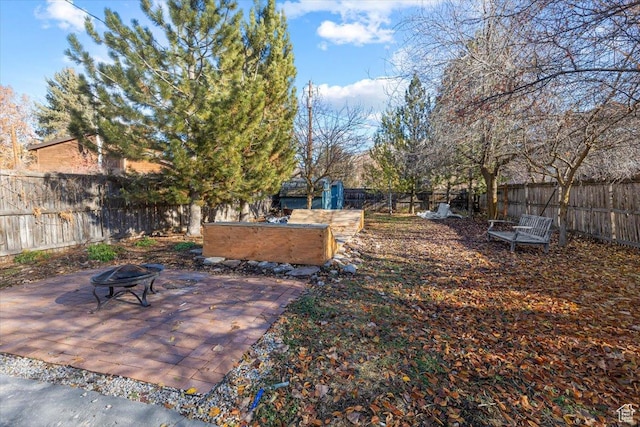 138 Crockett Ave, Logan, UT 84321 - fenced backyard featuring an outdoor fire pit and a patio