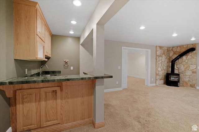 1375 E 260 N, Logan, UT 84321 - bar with light brown cabinets, sink, a wood stove, and light carpet