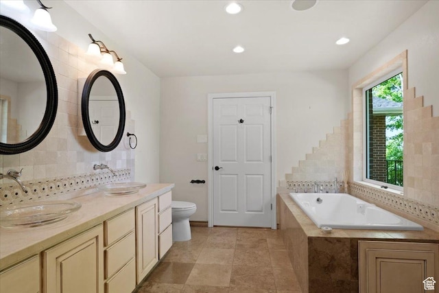 1375 E 260 N, Logan, UT 84321 - bathroom featuring decorative backsplash, vanity, a relaxing tiled tub, and toilet