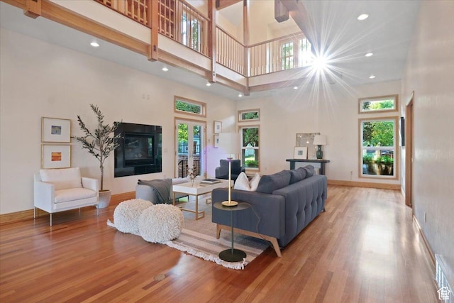 1375 E 260 N, Logan, UT 84321 - living room featuring hardwood / wood-style flooring, a towering ceiling, and a tile fireplace