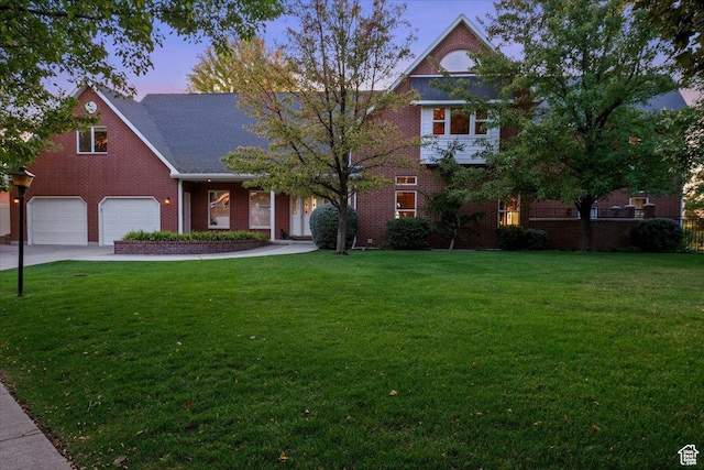 view of front of property with a yard and a garage