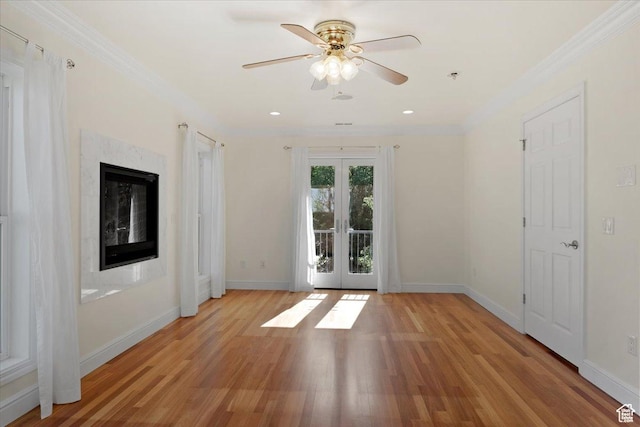 1375 E 260 N, Logan, UT 84321 - spare room featuring french doors, ceiling fan, ornamental molding, a fireplace, and light hardwood / wood-style floors