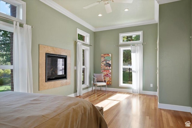 1375 E 260 N, Logan, UT 84321 - bedroom featuring multiple windows, ceiling fan, a tile fireplace, and light wood-type flooring