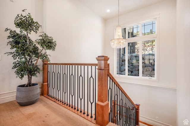 6736 E Via Cortina, Huntsville, UT 84317 - hallway with a notable chandelier and hardwood / wood-style flooring