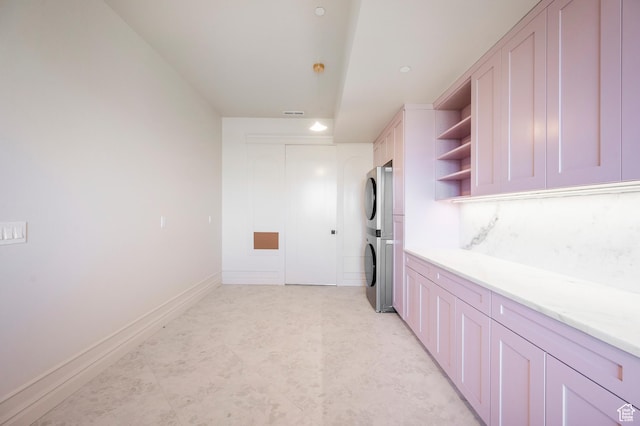 6736 E Via Cortina, Huntsville, UT 84317 - kitchen featuring light stone counters and stacked washing maching and dryer