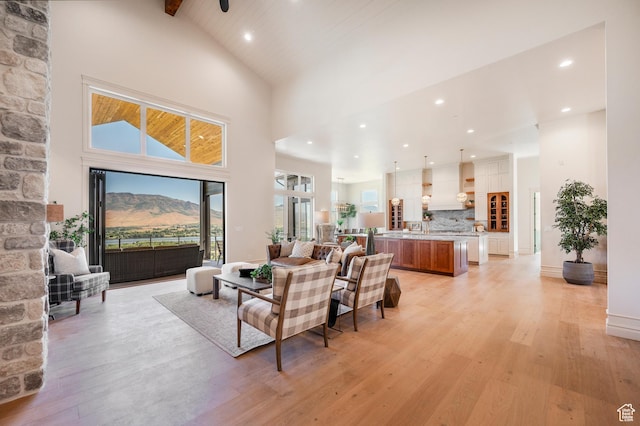 6736 E Via Cortina, Huntsville, UT 84317 - living room with a mountain view, ceiling fan, high vaulted ceiling, and light hardwood / wood-style flooring