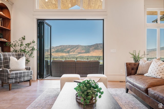 6736 E Via Cortina, Huntsville, UT 84317 - living room with a mountain view, a high ceiling, and hardwood / wood-style flooring