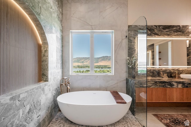 6736 E Via Cortina, Huntsville, UT 84317 - bathroom with a washtub, vanity, tile walls, a mountain view, and tile patterned flooring