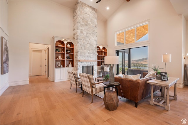 6736 E Via Cortina, Huntsville, UT 84317 - living room with light wood-type flooring, ornate columns, built in shelves, high vaulted ceiling, and a fireplace