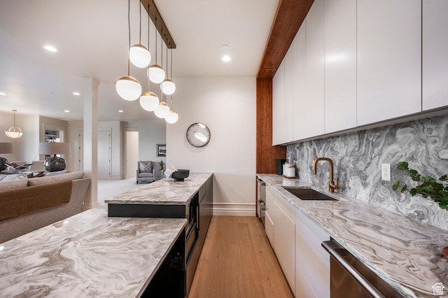 6736 E Via Cortina, Huntsville, UT 84317 - kitchen with light wood-type flooring, white cabinetry, sink, and hanging light fixtures