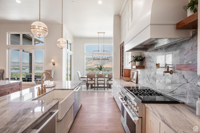 6736 E Via Cortina, Huntsville, UT 84317 - kitchen with light stone counters, premium range hood, stainless steel stove, and tasteful backsplash