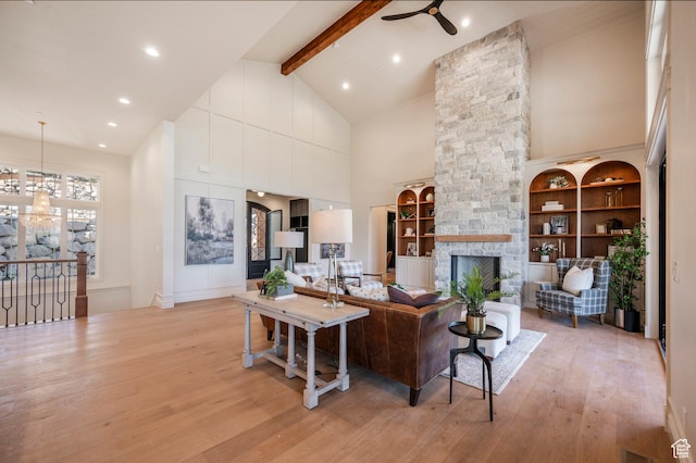 6736 E Via Cortina, Huntsville, UT 84317 - living room with a fireplace, ceiling fan, high vaulted ceiling, beamed ceiling, and light hardwood / wood-style floors