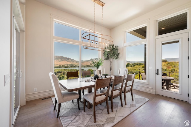 6736 E Via Cortina, Huntsville, UT 84317 - dining area featuring a water and mountain view, wood-type flooring, and a notable chandelier