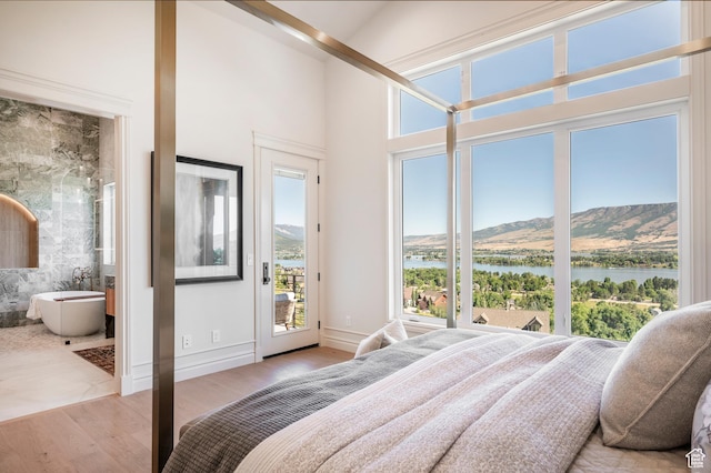 6736 E Via Cortina, Huntsville, UT 84317 - bedroom featuring access to exterior, a water and mountain view, high vaulted ceiling, and light hardwood / wood-style flooring