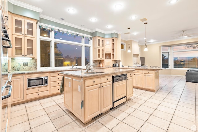 kitchen with dishwashing machine, a kitchen island with sink, ceiling fan, pendant lighting, and stainless steel microwave