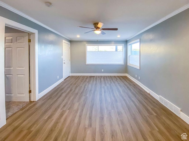 empty room with crown molding, ceiling fan, and light hardwood / wood-style flooring