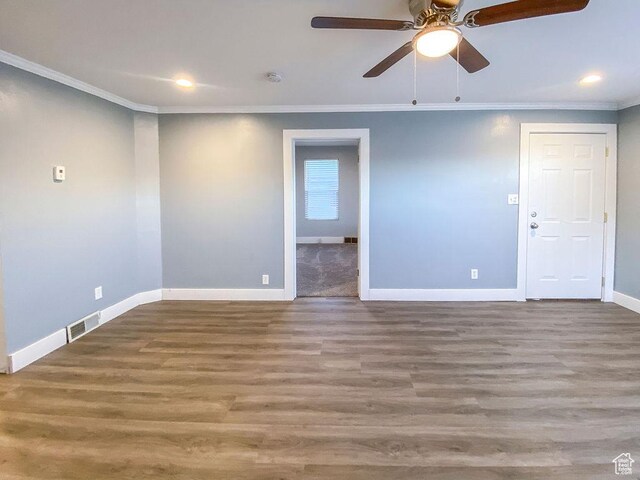 empty room featuring crown molding, hardwood / wood-style floors, and ceiling fan