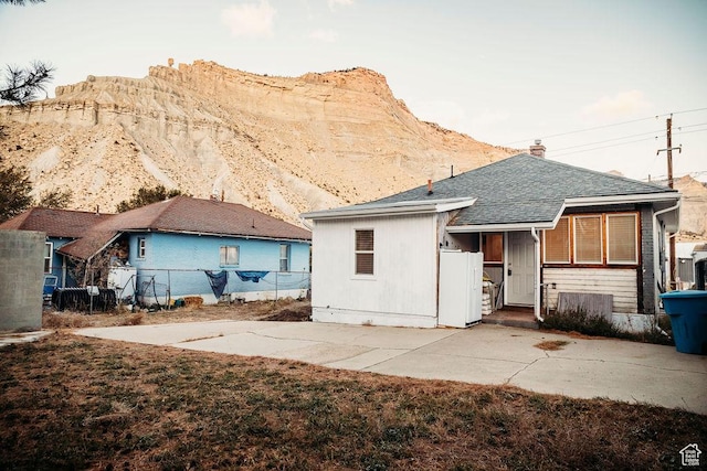 back of house featuring a mountain view