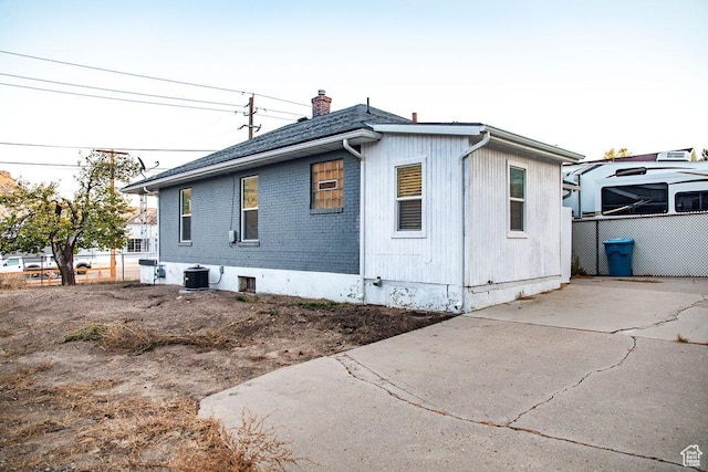 view of property exterior featuring cooling unit and a patio area