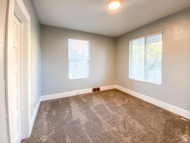unfurnished room with carpet floors