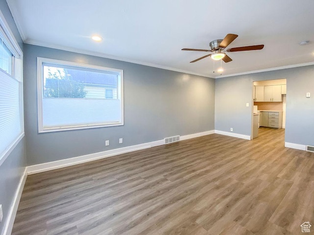 empty room featuring ornamental molding, ceiling fan, and light hardwood / wood-style floors