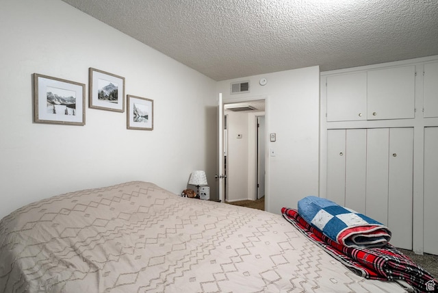 carpeted bedroom with a textured ceiling