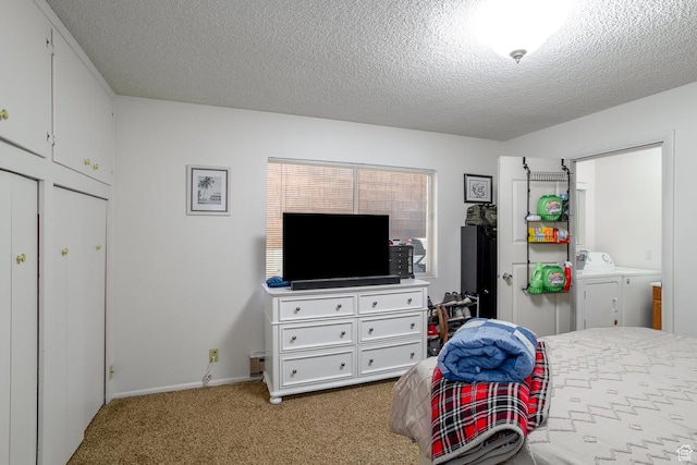 carpeted bedroom with separate washer and dryer and a textured ceiling