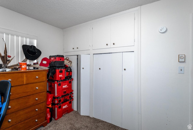 bedroom featuring a textured ceiling, carpet floors, and a closet