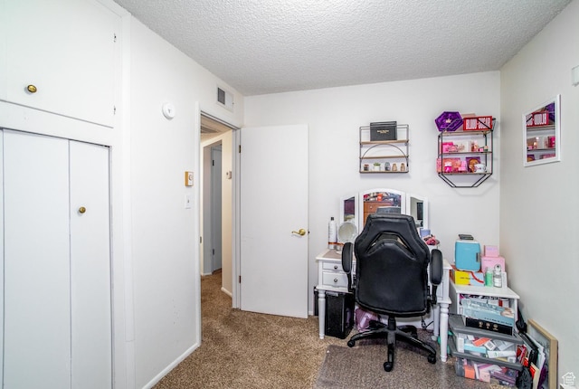 carpeted home office with a textured ceiling