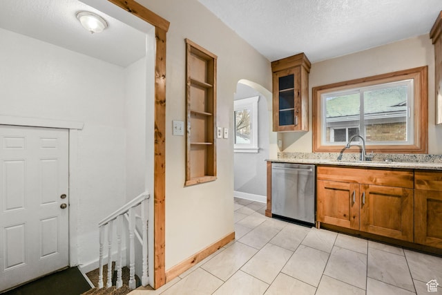 845 Binford St, Ogden, UT 84401 - kitchen featuring light stone countertops, stainless steel dishwasher, a textured ceiling, sink, and light tile patterned floors