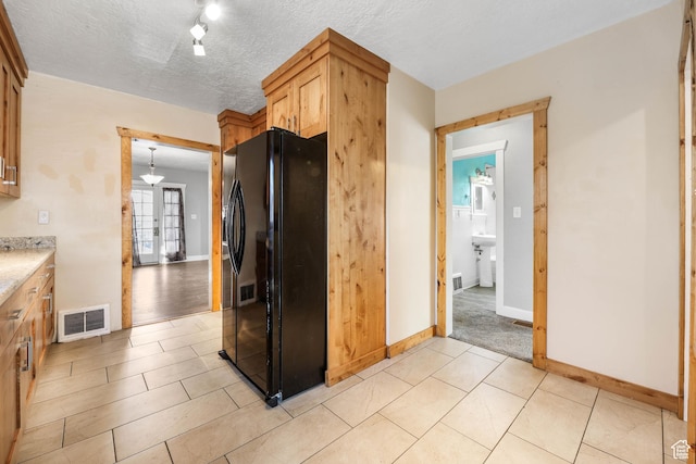 845 Binford St, Ogden, UT 84401 - kitchen featuring french doors, sink, hanging light fixtures, a textured ceiling, and black fridge with ice dispenser