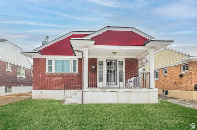 view of front facade with covered porch and a front yard