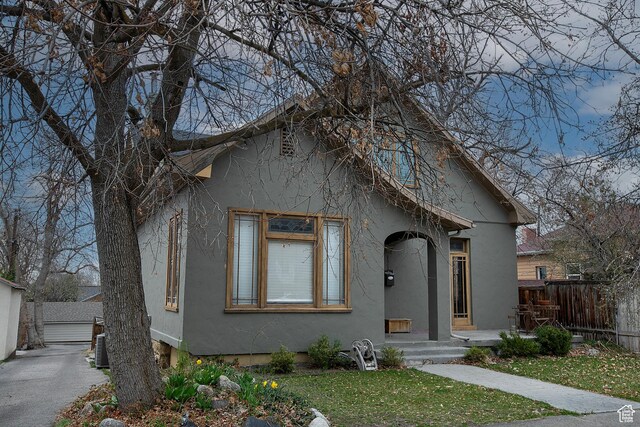 121 T St, Salt Lake City, UT 84103 - view of front of home with stucco siding, fence, a detached garage, and a front yard