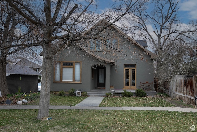 121 T St, Salt Lake City, UT 84103 - bungalow with stucco siding, fence, and a front yard