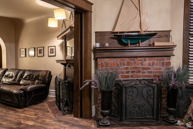 121 T St, Salt Lake City, UT 84103 - living area with arched walkways, baseboards, wood finished floors, and a fireplace