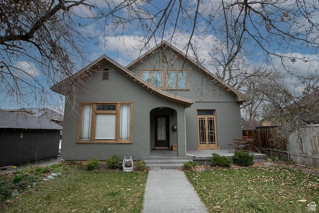 121 T St, Salt Lake City, UT 84103 - bungalow-style home featuring fence, a patio area, a front yard, and stucco siding