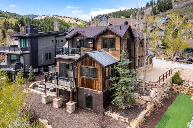 rear view of property featuring a mountain view